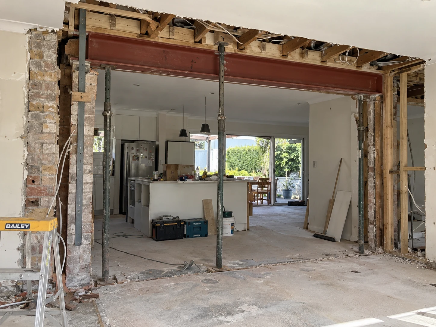 Steel beam installed above a new opening in a brick wall